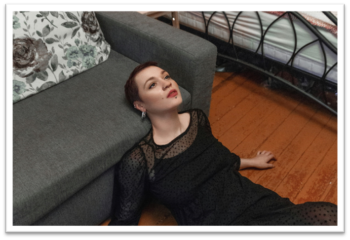 woman staring into space laying on floor