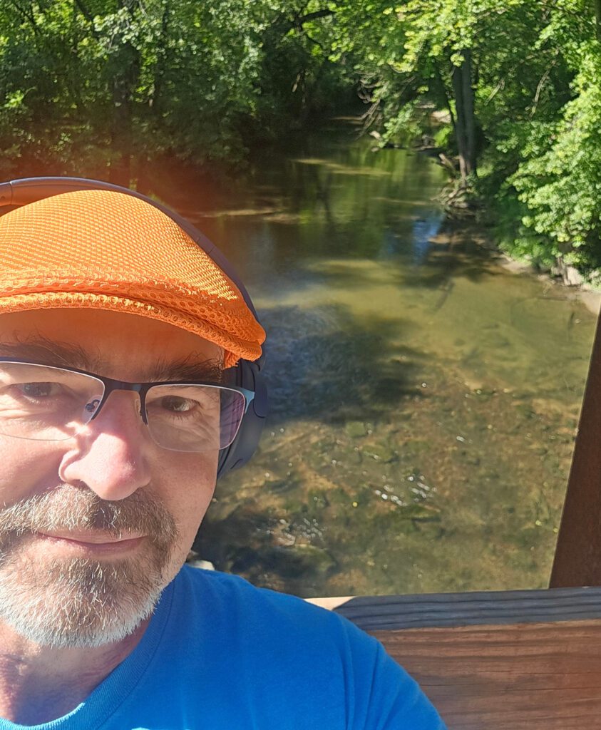 Daniel Belum near water in hat